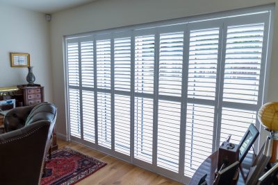 white tracked shutters
